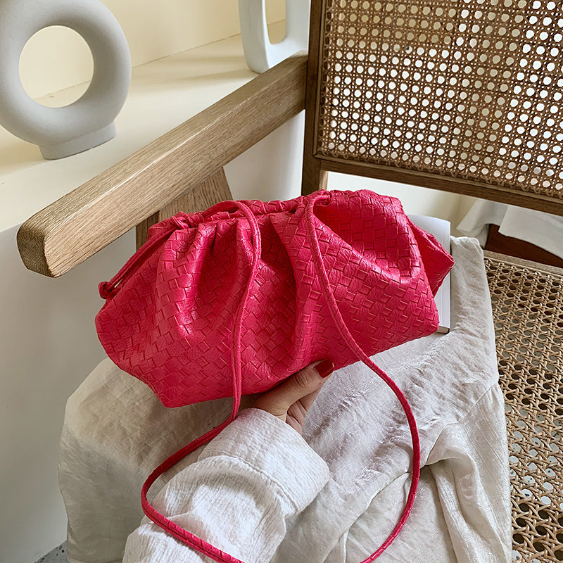 Hand holding diagonal cloud bag