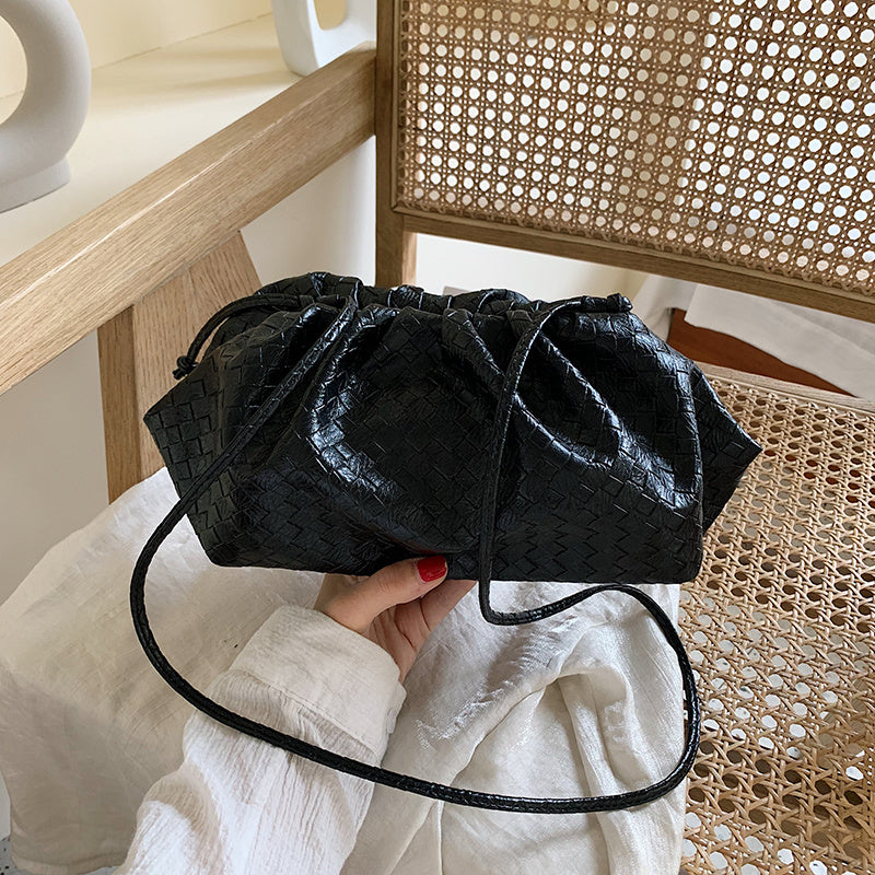 Hand holding diagonal cloud bag